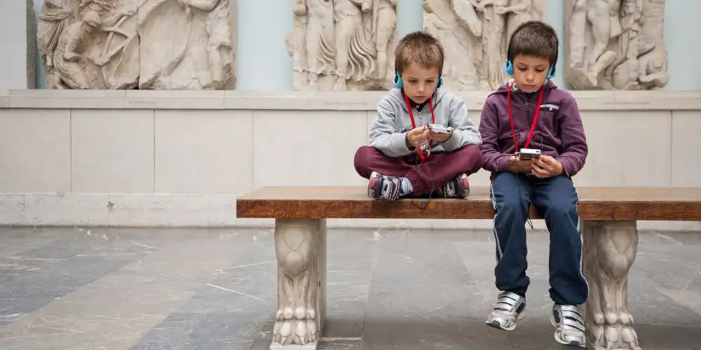 Children listening to the audioguide at the Pergamon Museum in Berlin