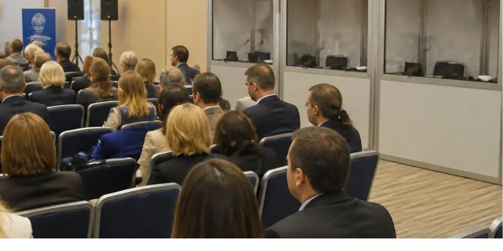 Empty conference hall with simultaneous interpretation equipment, representing the risk of interpreters not showing up.