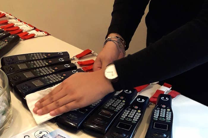 Museum staff cleaning audio guide devices